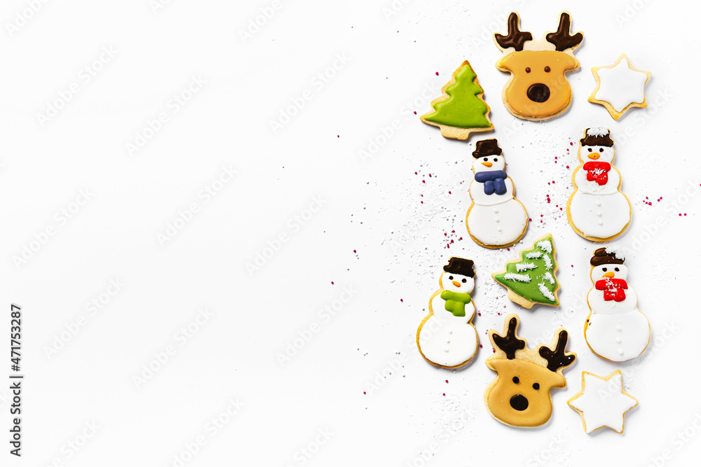 Sugar Christmas cookies on white background. Snowman, elk. fir, stars shapes. Top view and copy space