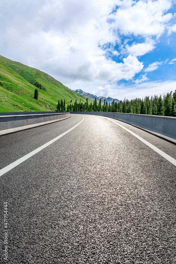 Asphalt road and mountain under blue sky. Highway and mountain background. Asphalt road and mountain under blue sky. Highway and mountain background.