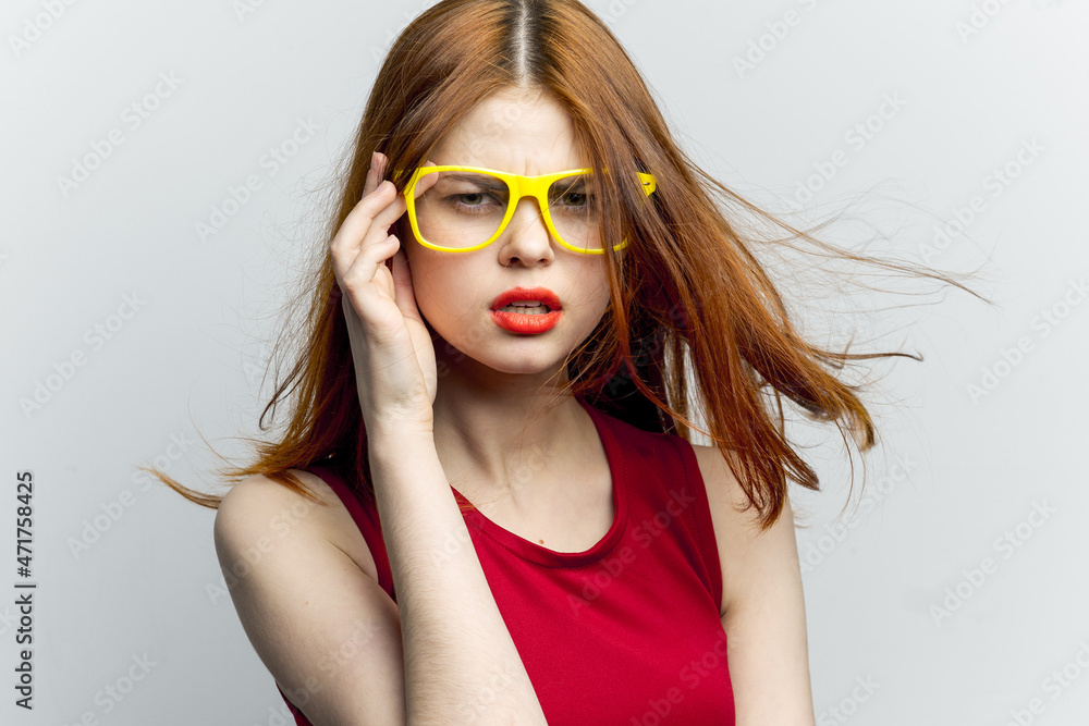 emotional woman in red dress yellow glasses posing emotional woman in red dress yellow glasses posing