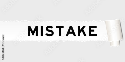 Ripped gray paper background that have word mistake under torn part
