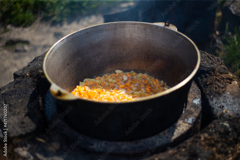 Large cauldron with a fluffy soup on the street