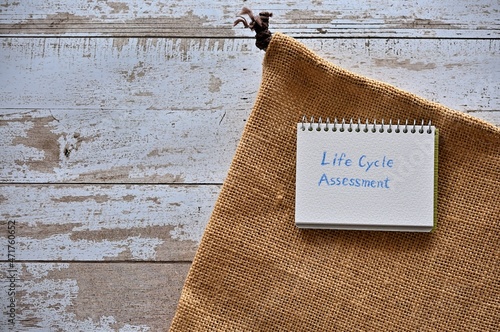 There is a small scetchbook with the word Life Cycle Assessment with hemp cloth. photo