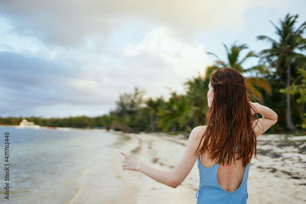 woman in blue swimsuit on the beach island lifestyle woman in blue swimsuit on the beach island lifestyle