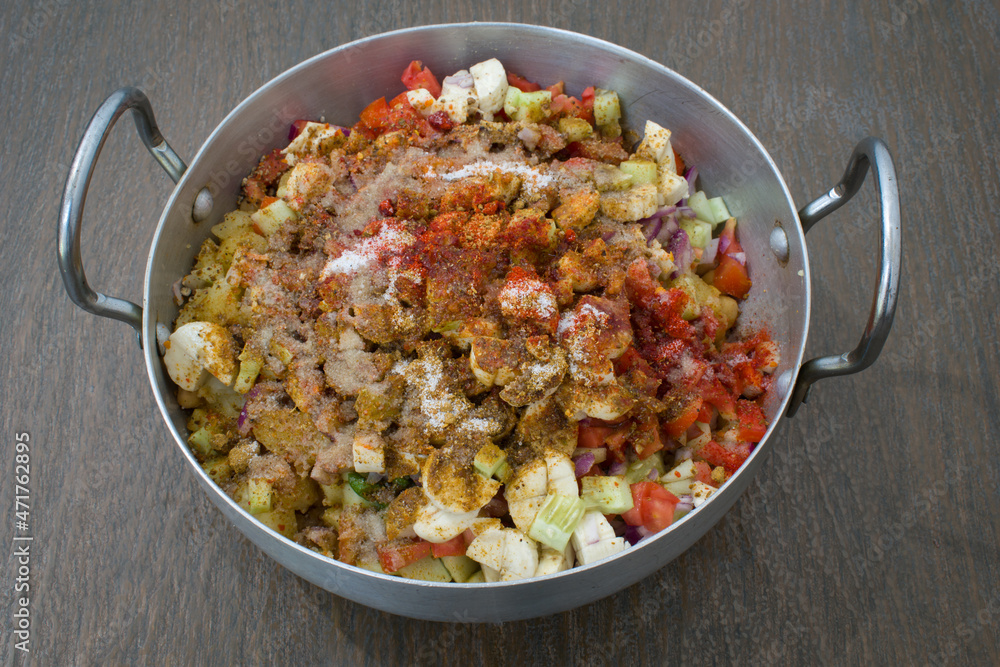 Indian delicious home made chaat of chickpeas, tomatoes, fruits, masalas in aluminium wok Indian delicious home made chaat of chickpeas, tomatoes, fruits, masalas in aluminium wok