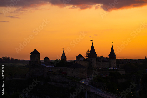 Silhouette of an old medieval castle during sunset