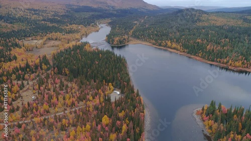 50fps aerial view camping caravan near river autumn landscape along Ammarnas National Park in Lapland Sweden photo