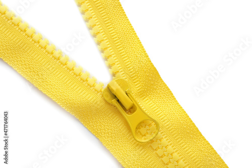 Yellow zipper on white background, top view photo