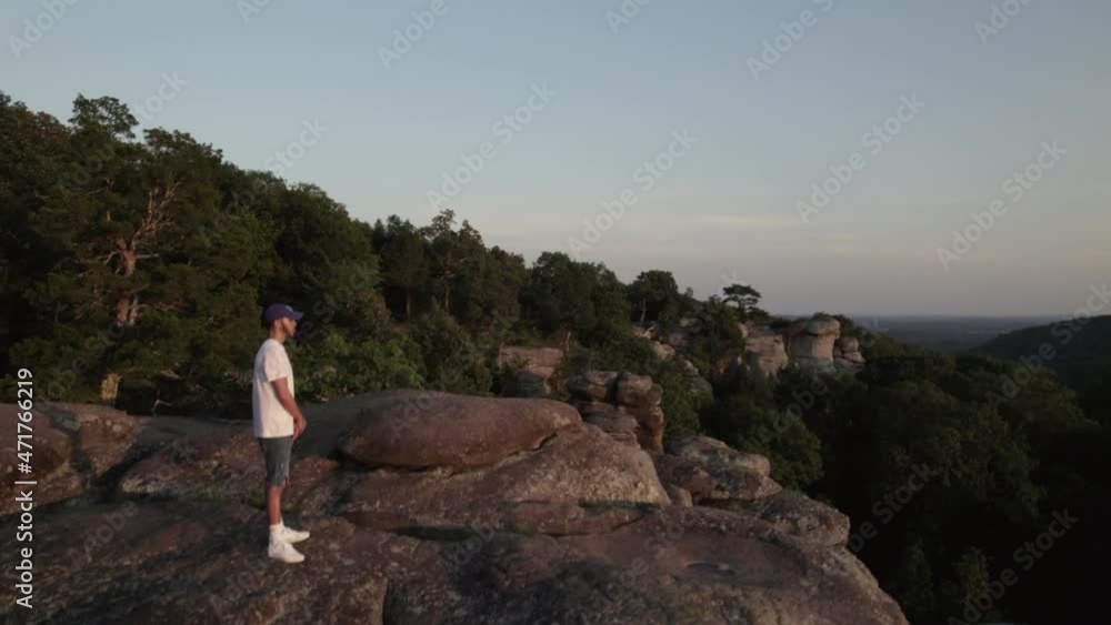 Aerial drone, man standing on edge of cliff rise over Garden of the Gods, Southern Illinois Aerial drone, man standing on edge of cliff rise over Garden of the Gods, Southern Illinois