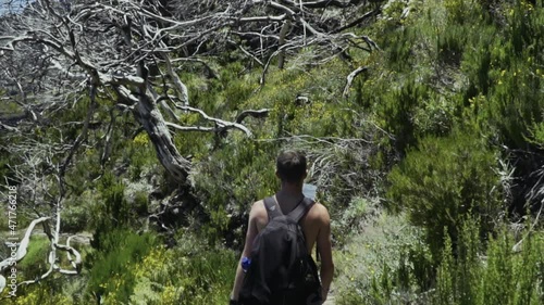 Panning down to hiker walking along PR1 Pico do Arieiro - Pico Ruivo trail