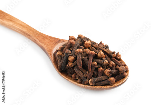 Wooden spoon with aromatic dry cloves isolated on white, closeup