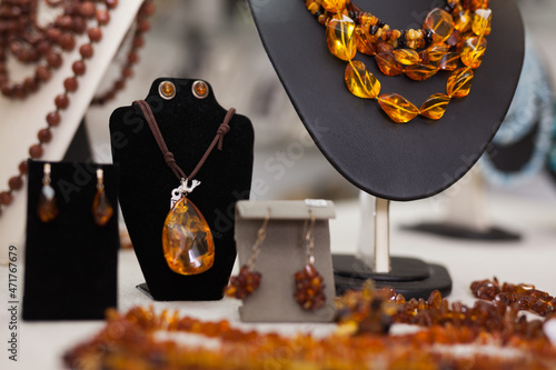 Fotografering Counter with amber jewelry in store. High quality photo