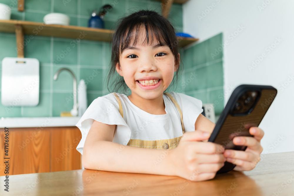 Asian child using smartphone at home Asian child using smartphone at home