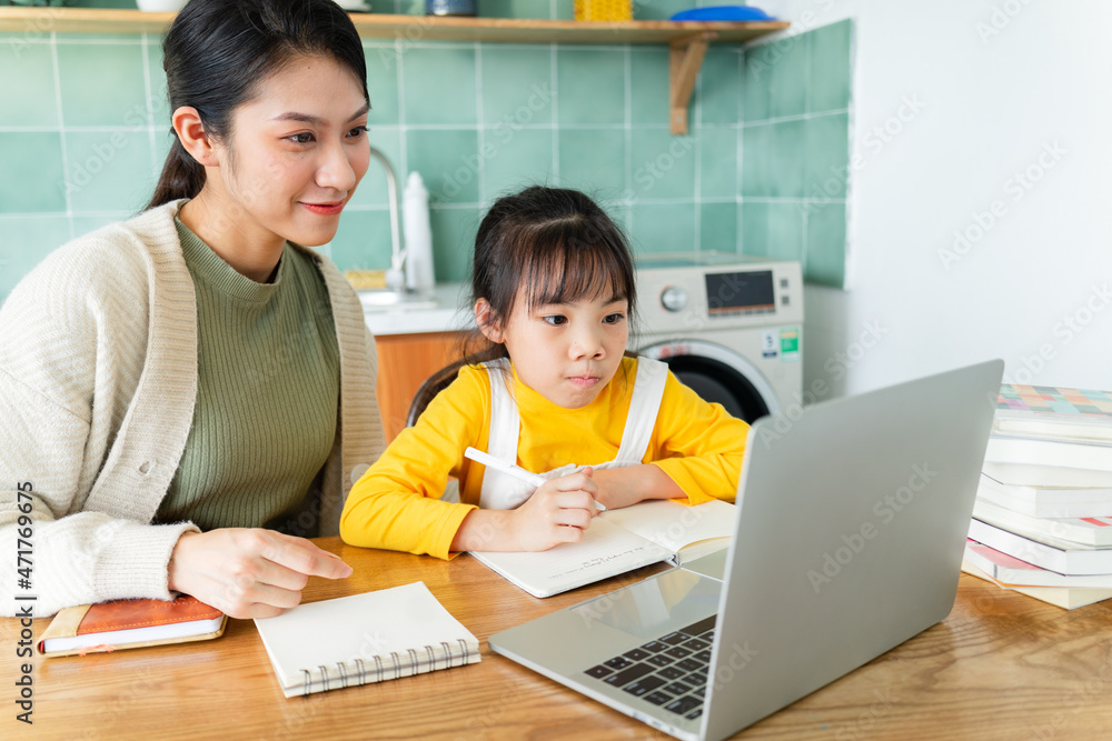 Asian Mother and daughter studying together at home Asian Mother and daughter studying together at home