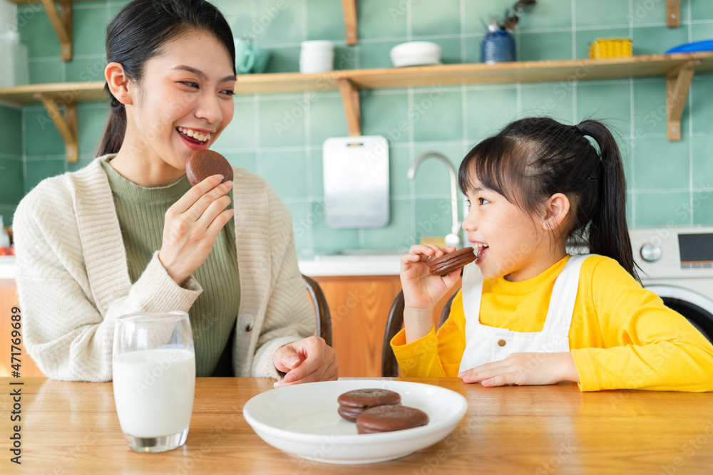 Mother and daughter eating breakfast together Mother and daughter eating breakfast together