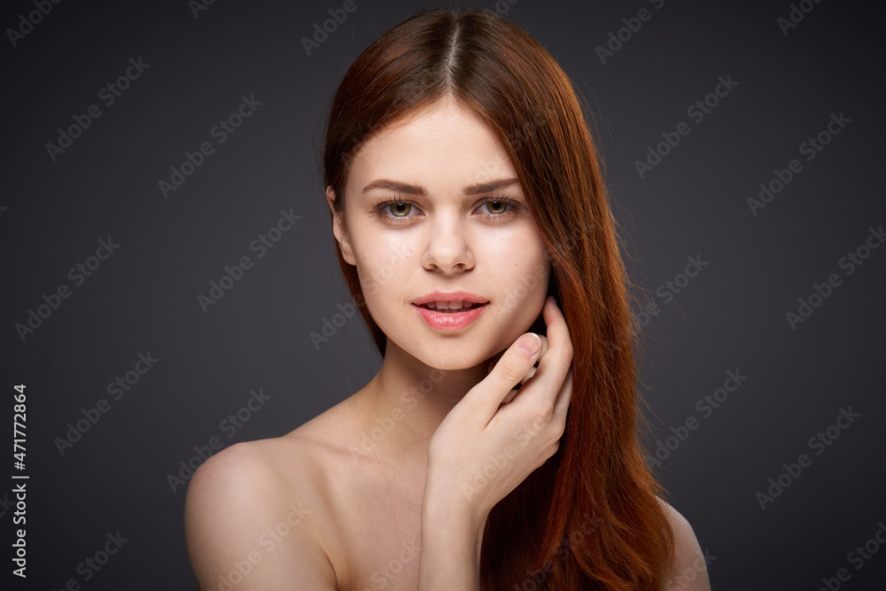 pretty red-haired woman naked shoulders posing dark background pretty red-haired woman naked shoulders posing dark background