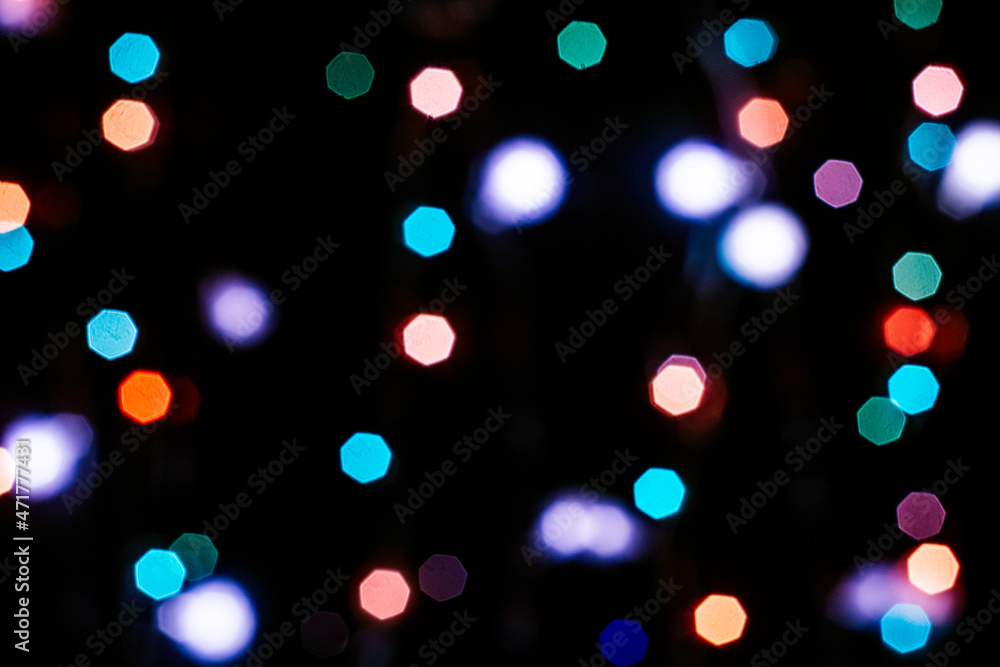 black abstract background with multicolored lights with bokeh in blur