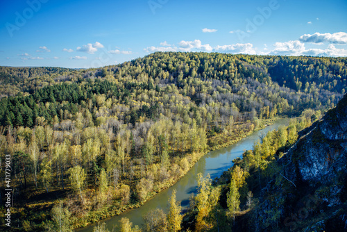 Beautiful view of wooded hills and river bends under clear blue sky. Peaceful natural landscape in a national park. Nature of Siberia.