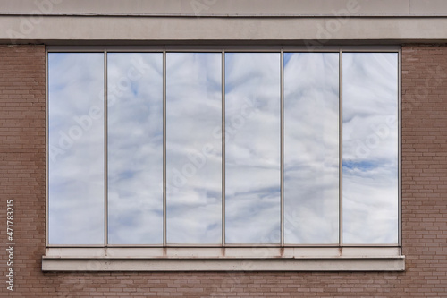 Window of the Lutheran Church in Finnish Kerava town with the reflection of clouds.