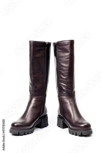 Black leather women’s boots fastened with a zipper. Background for shoes.