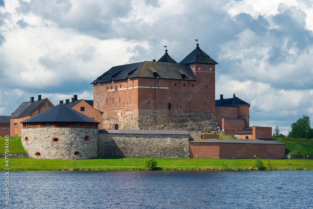View of the ancient fortress of Hameenlinna from the lake, cloudy July day. Finland