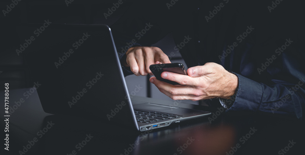 Businessman using a smartphone and notebook in a moddy office Businessman using a smartphone and notebook in a moddy office