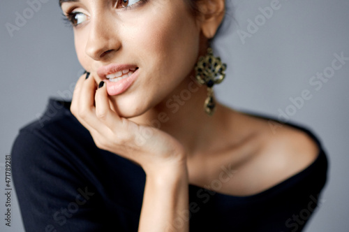 beautiful woman earrings jewelry posing black dress lifestyle studio