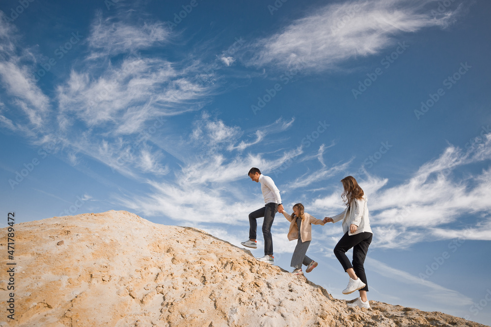 A young family with a daughter among the sand and blue sky 3309. A young family with a daughter among the sand and blue sky 3309.