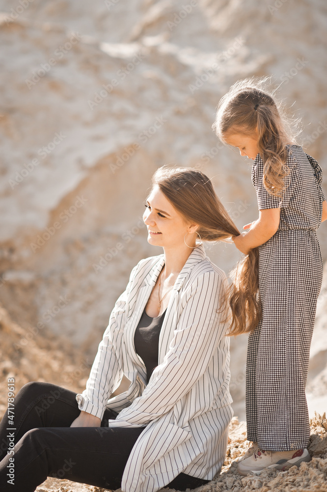 Mom plays with her daughter in nature among the sands 3362. Mom plays with her daughter in nature among the sands 3362.