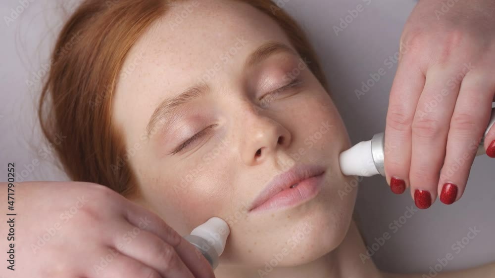 A happy relaxed woman receives a rejuvenating cosmetic hardware procedure at a cosmetology center A happy relaxed woman receives a rejuvenating cosmetic hardware procedure at a cosmetology center