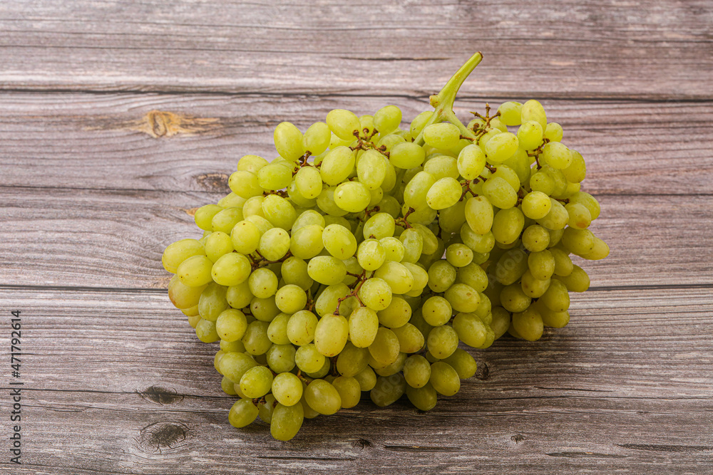 Green grape branch over background Green grape branch over background