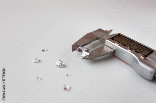 a lot of diamonds and a measuring device in a jewelry workshop