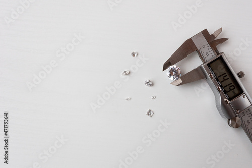 a lot of diamonds and a measuring device in a jewelry workshop