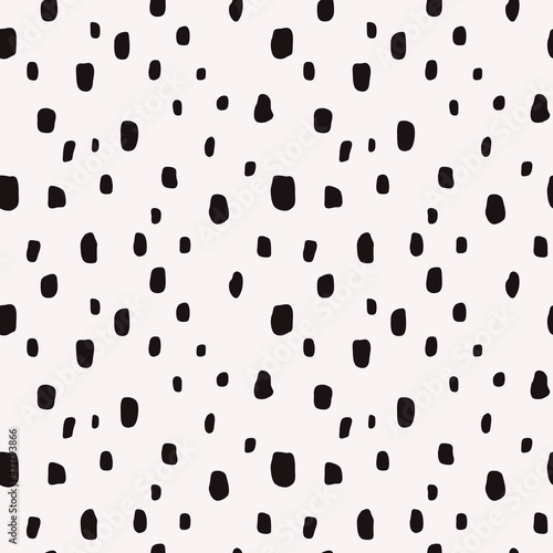 Black spots are randomly scattered across the white canvas. Seamless vector background with shapeless spots.