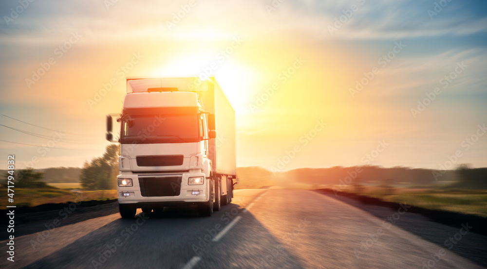 Obraz premium Truck with container on highway with sun light. Concept cargo transportation banner. Blur move effect