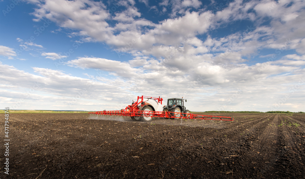 Tractor spraying land in sunset. Tractor spraying land in sunset.