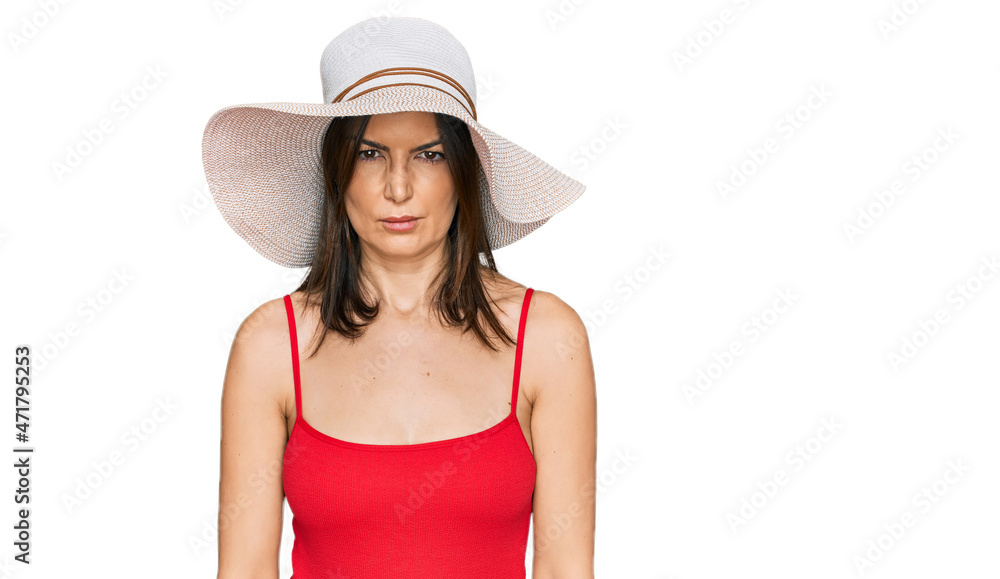 Beautiful brunette woman wearing swimsuit and summer hat skeptic and nervous, frowning upset because of problem. negative person. Beautiful brunette woman wearing swimsuit and summer hat skeptic and nervous, frowning upset because of problem. negative person.