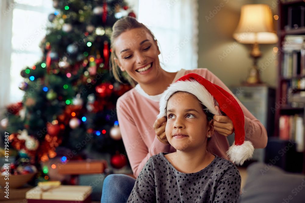 Happy mother has fun with her daughter while spending Christmas together at home. Happy mother has fun with her daughter while spending Christmas together at home.