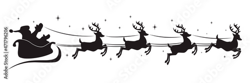 Fototapet Silhouette of santa claus riding on reindeer sleigh