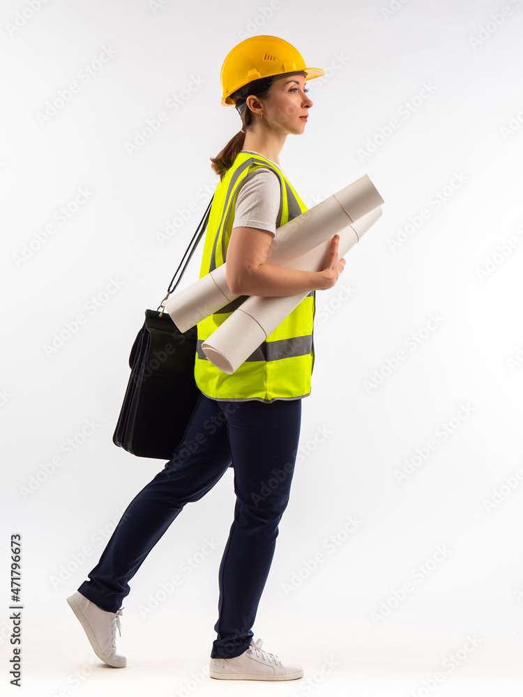 Woman architect with papers. Architect in reflective vest. Employee of construction company. Builder girl on white background. She has architectural drawings or construction documents in her hands Woman architect with papers. Architect in reflective vest. Employee of construction company. Builder girl on white background. She has architectural drawings or construction documents in her hands