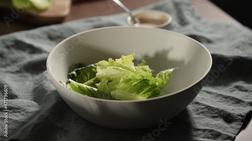 baby romaine leaves in white bowl