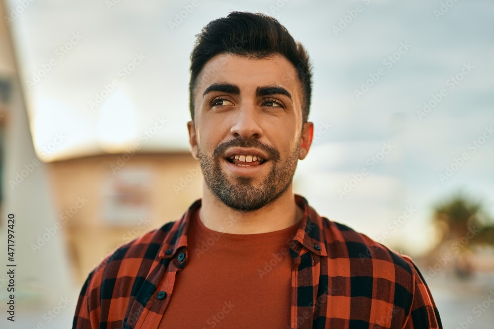 Young hispanic man smiling happy standing at the city. Young hispanic man smiling happy standing at the city.