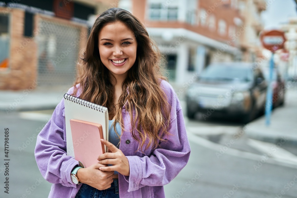 Young hispanic student woman smiling happy standing at the city. Young hispanic student woman smiling happy standing at the city.