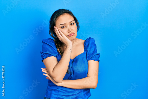 Young hispanic girl wearing casual clothes thinking looking tired and bored with depression problems with crossed arms.