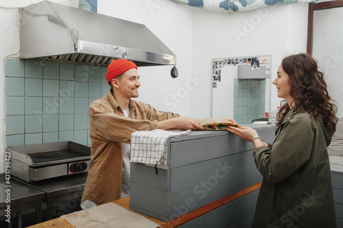 girl picks up her order in street food cafe