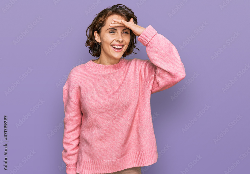 Young hispanic woman wearing casual clothes very happy and smiling looking far away with hand over head. searching concept. Young hispanic woman wearing casual clothes very happy and smiling looking far away with hand over head. searching concept.