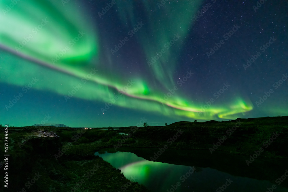Aurora borealis lights and lake reflections