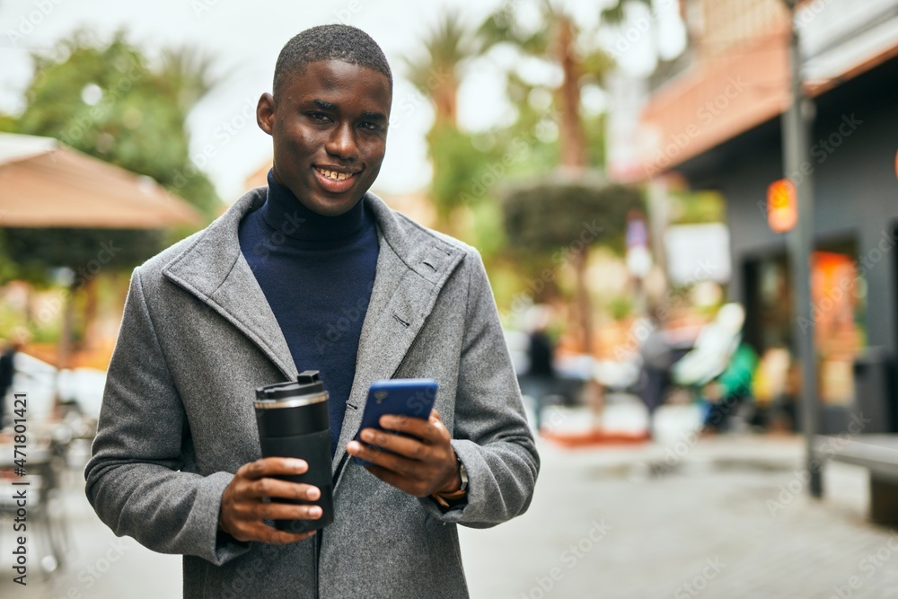 Young african american man using smartphone drinking coffee at the city Young african american man using smartphone drinking coffee at the city