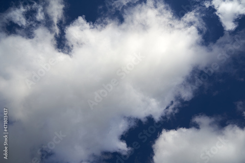 White clouds against blue sky. From below. Ideal as background.