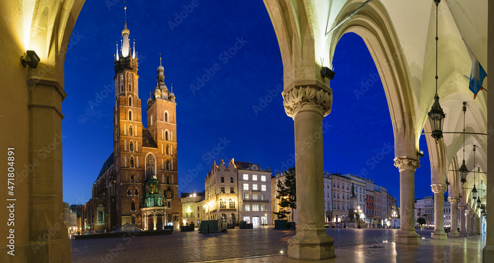 Night photography of the Main Square in Krakow. View from the Cloth hall on the St. Mary's Basilica. Krakow, Poland.