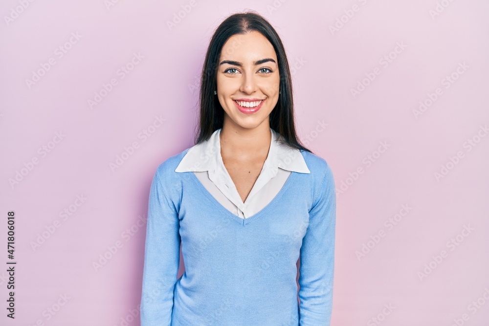 Beautiful woman with blue eyes standing over pink background with a happy and cool smile on face. lucky person. Beautiful woman with blue eyes standing over pink background with a happy and cool smile on face. lucky person.